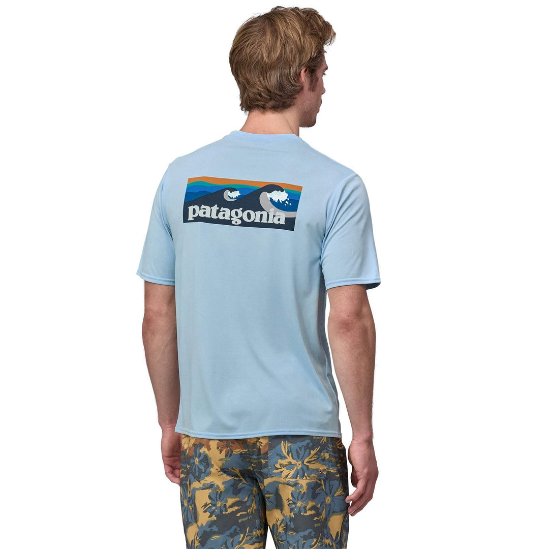 Men's blue graphic shirt with Patagonia logo, designed for versatility and odor control; made from recycled polyester.