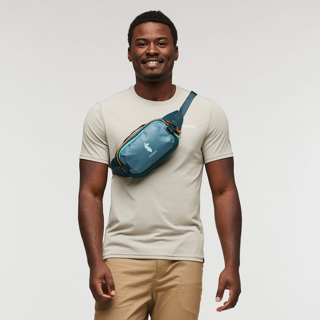 Allpa X 1.5L hip pack worn by a person, teal color with adjustable strap.