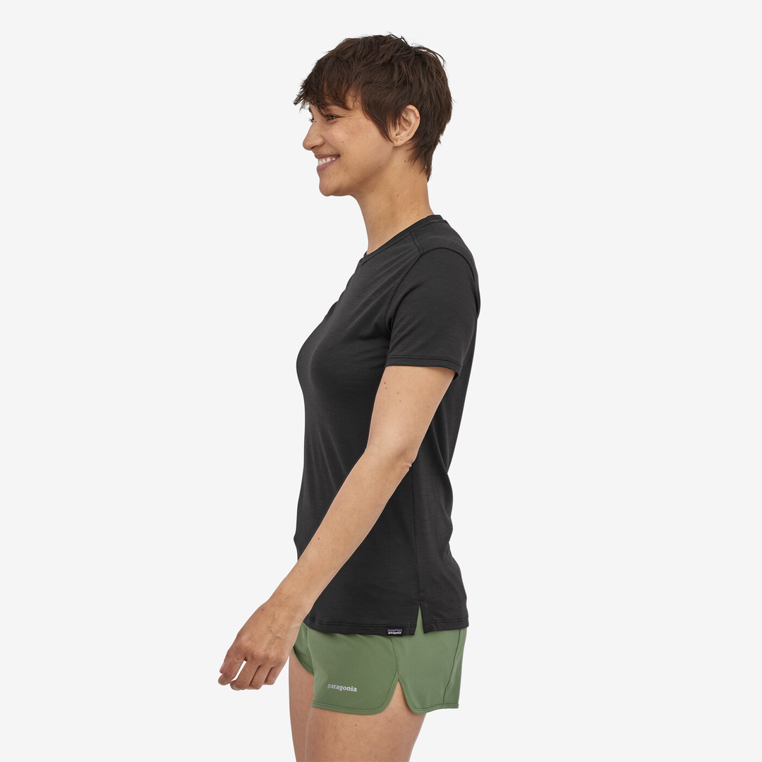 Woman wearing W's Cap Cool Merino Blend Shirt in black, side view.