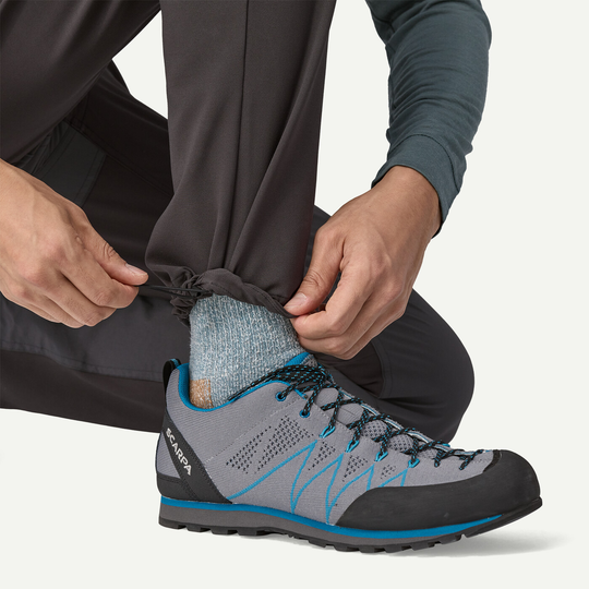 M's Terravia Alpine Pants with adjustable ankle, ideal for alpine climbing, paired with Scarpa shoes.