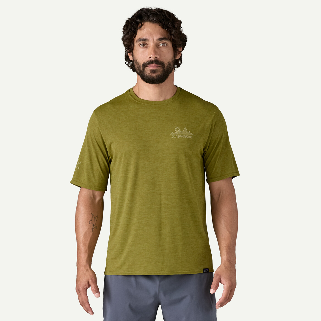 M's Cap Cool Daily Graphic Shirt in green; made with recycled polyester, odor control, versatile for trail and water activities.