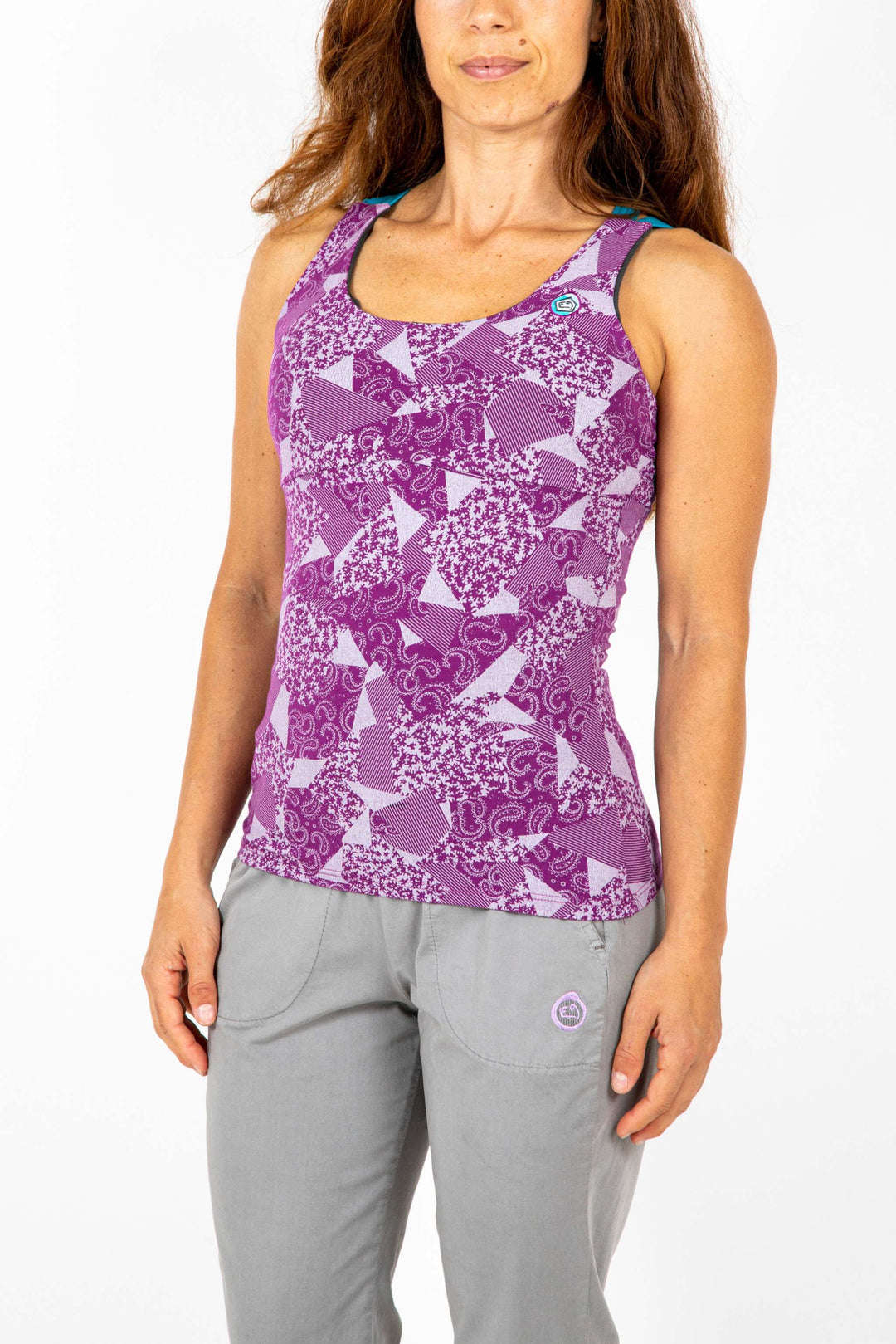 Sleeveless top with built-in bra in purple geometric print, featuring elastic straps and front embroidery, made from organic cotton.