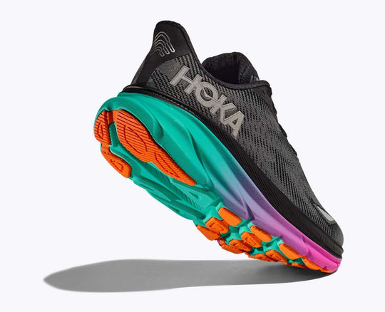 HOKA Clifton 9 Gtx running shoe with GORE-TEX, multicolored sole, and reflective features for all-weather conditions.