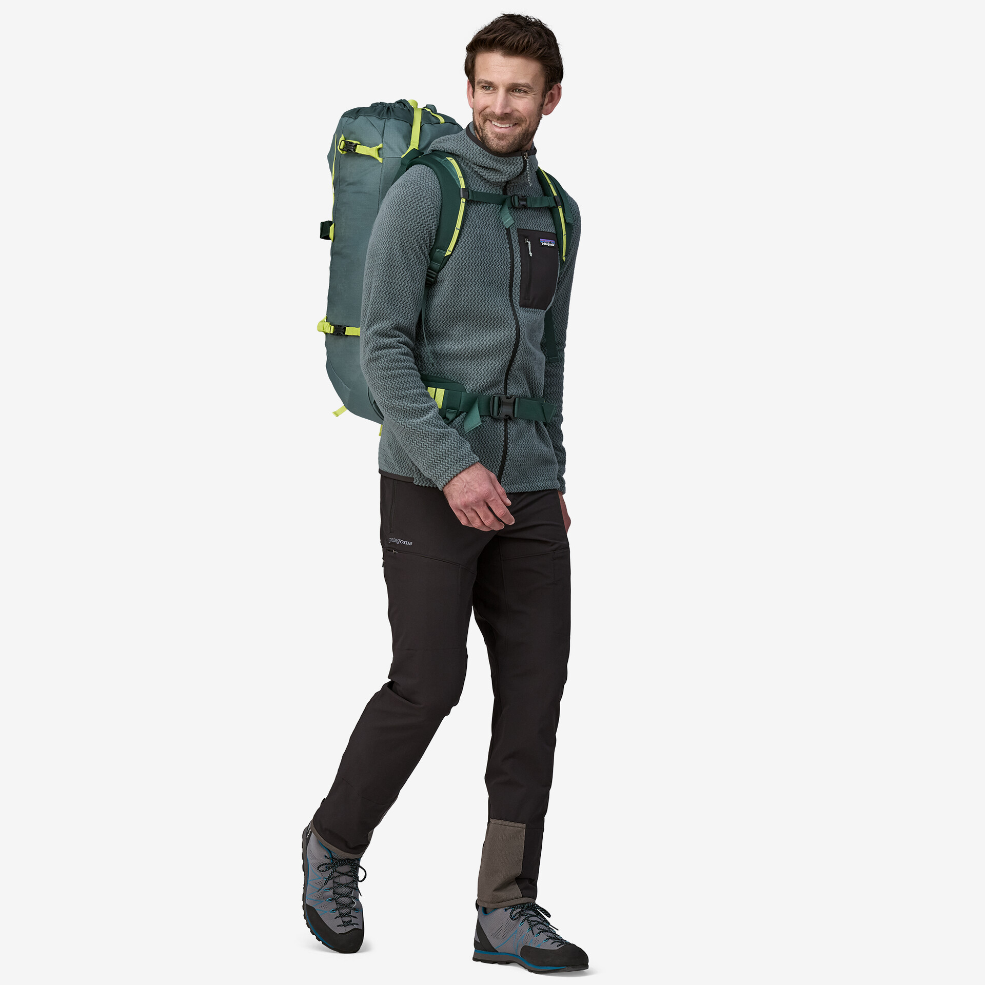 Ascensionist 35L backpack on a person, ideal for alpine climbing, with versatile features and adjustable straps.