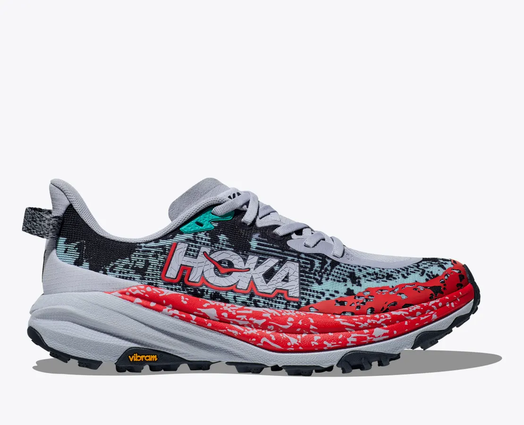 Trail running shoe, HOKA Speedgoat 6, with lightweight mesh upper, aggressive traction, and vibrant red and black design.