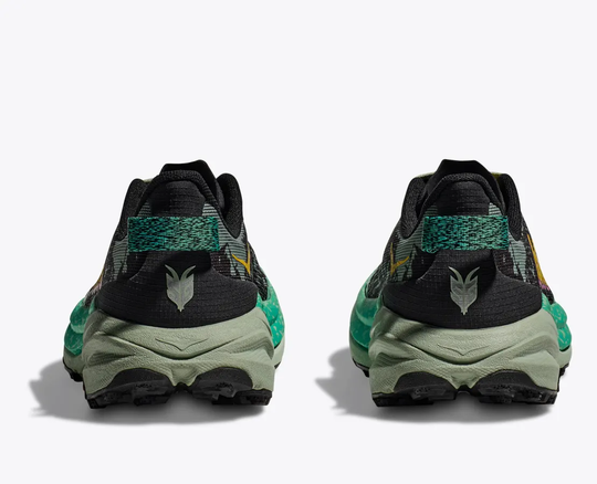 Speedgoat 6 trail running shoes in black and green, rear view.