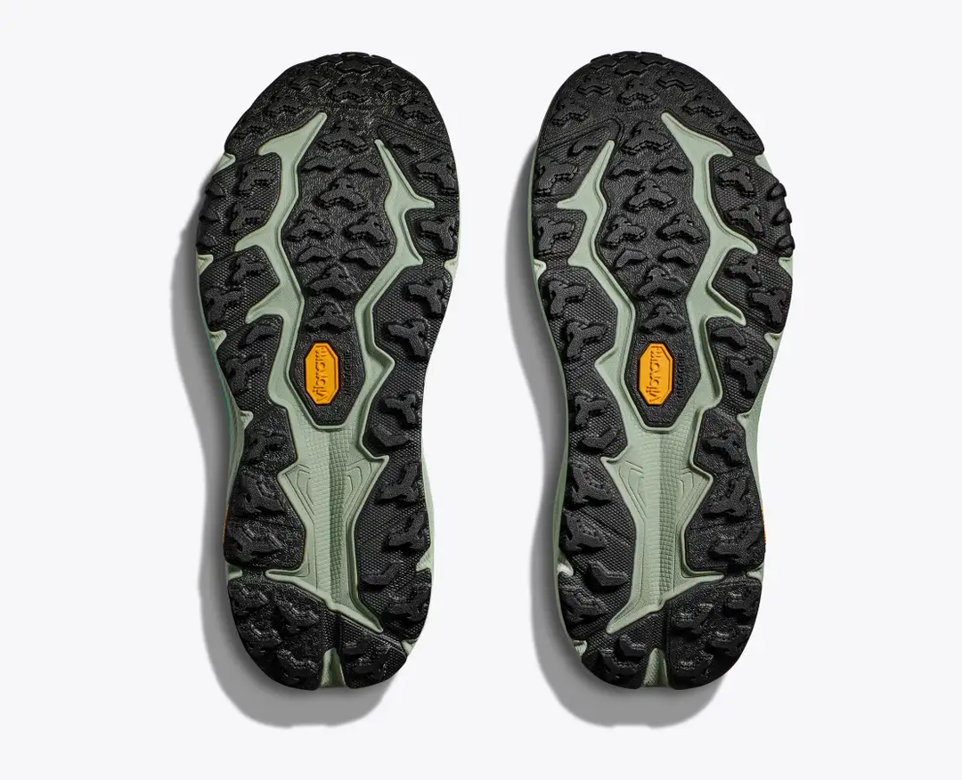 Trail running shoes with aggressive Vibram® Megagrip soles, showcasing the durable treads of the Speedgoat 6.
