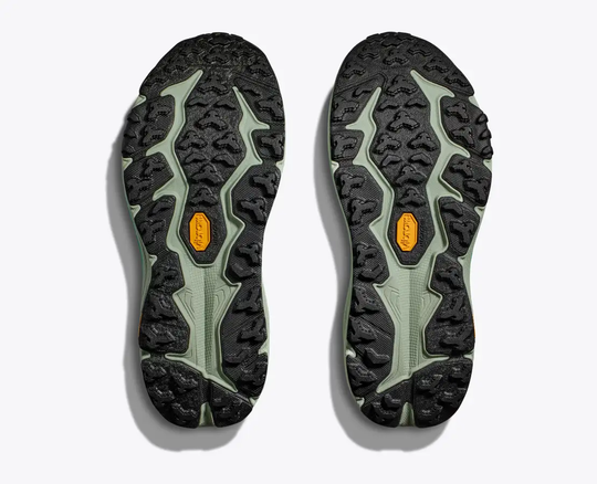 Trail running shoes with aggressive Vibram® Megagrip soles, showcasing the durable treads of the Speedgoat 6.