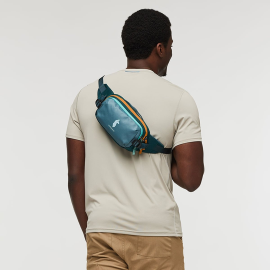 Allpa X 1.5L Hip Pack worn crossbody, easy-access design, durable travel companion.