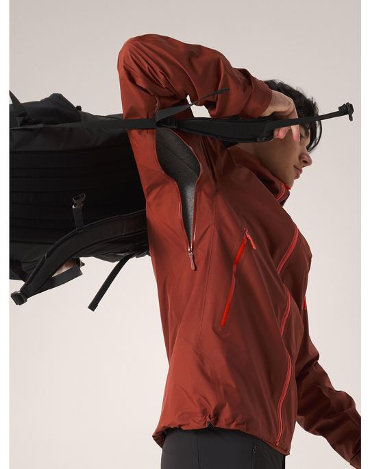 Beta SL Jacket M being worn by a person, featuring a red-brown color with orange zippers, showcasing lightweight and versatile design with GORE-TEX technology.