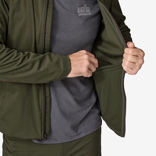 Wind Shield Jkt in olive green, showcasing soft shell fabric and interior pocket.