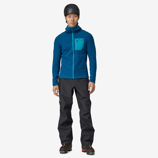 Alpinist wearing M's Triolet Pants in outdoor setting.