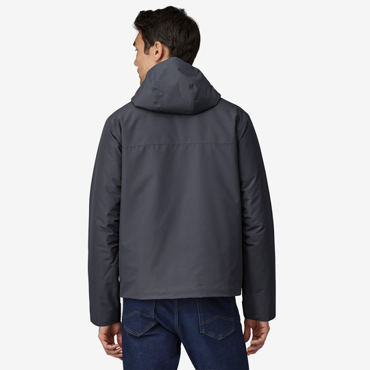 Windshadow Jkt in gray, worn by a man, showcasing adjustable hood and ripstop polyester fabric.