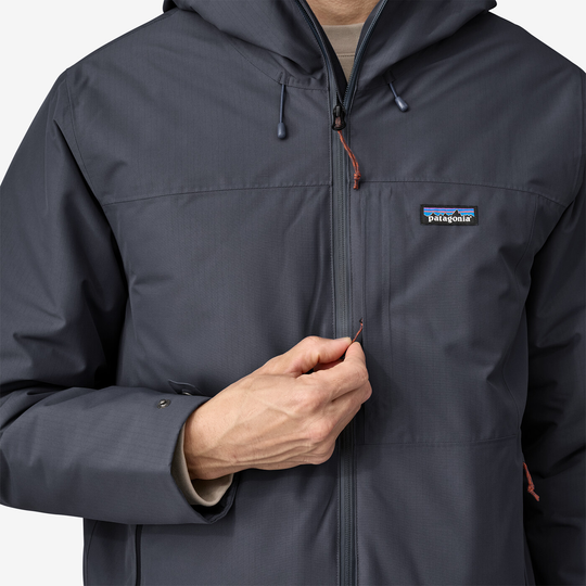Windshadow Jkt in dark gray with adjustable hood and zippered chest pocket.