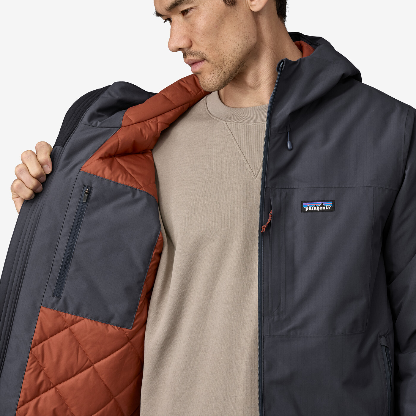 Men's Windshadow Jacket with adjustable hood and cuffs, made from recycled polyester, perfect for wet and chilly weather.
