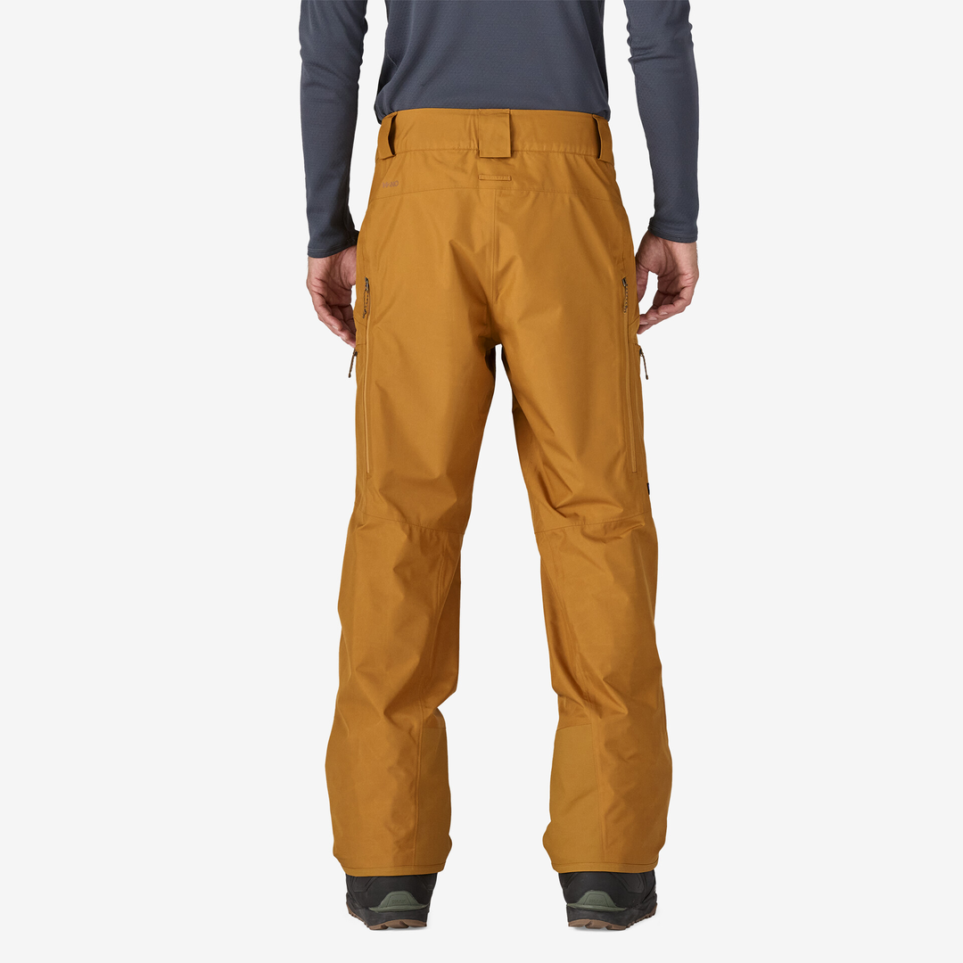 Men's Powder Town Pants in mustard color, featuring adjustable waistband and cargo pockets, shown from the back.