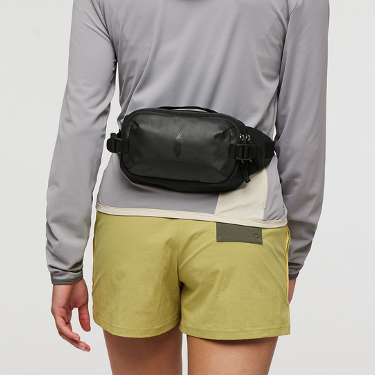 Allpa X 1.5L Hip Pack worn around the waist, black color, ideal for travel and outdoor activities.