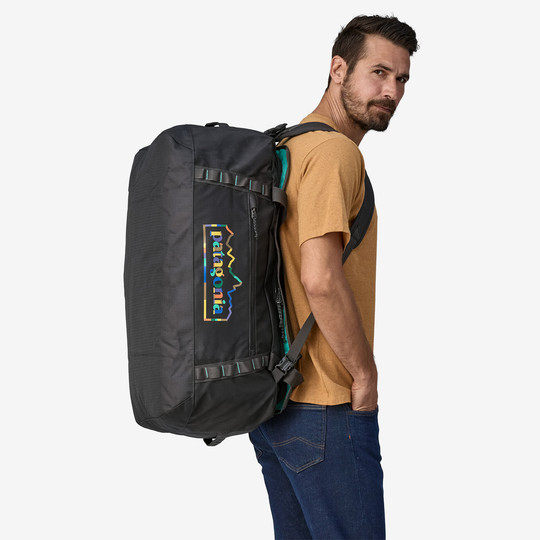 Black Hole Duffel 70L being carried on back, outdoor gear, large capacity, recycled materials.