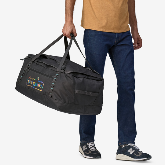 Black Hole Duffel 70L in use, lightweight and durable recycled fabric, ideal for adventure gear.