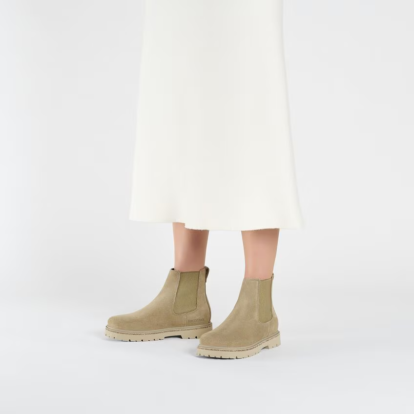 Suede leather women's slip-on ankle boots by BIRKENSTOCK, featuring cork elements and Deep Blue footbed.