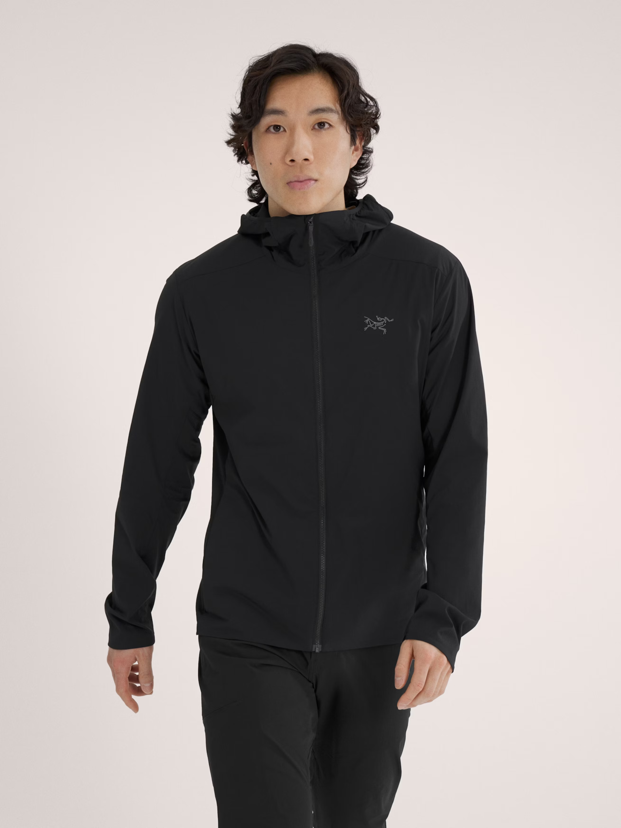 Man wearing black Atom SL Hoody for lightweight performance.