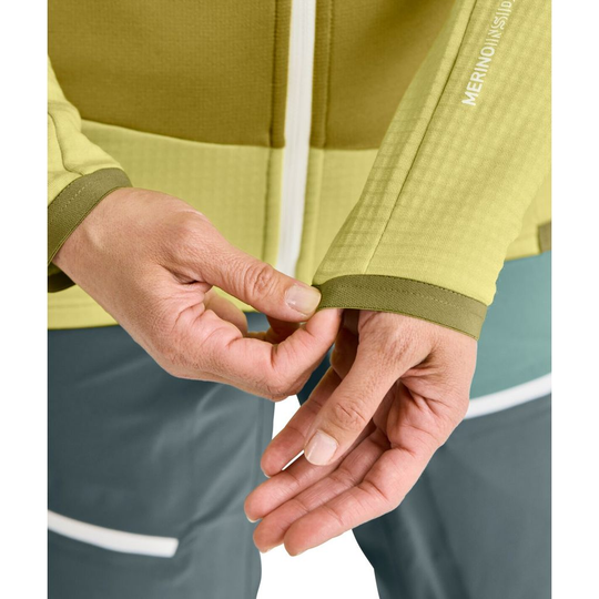 Fleece Grid Jacket W in yellow-green, showcasing the waffle structure cuff detail and breathable design for mountain tours.
