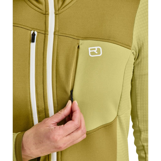 Women's fleece grid jacket with chest pocket, featuring a waffle structure for warmth and breathability, ideal for mountain tours.