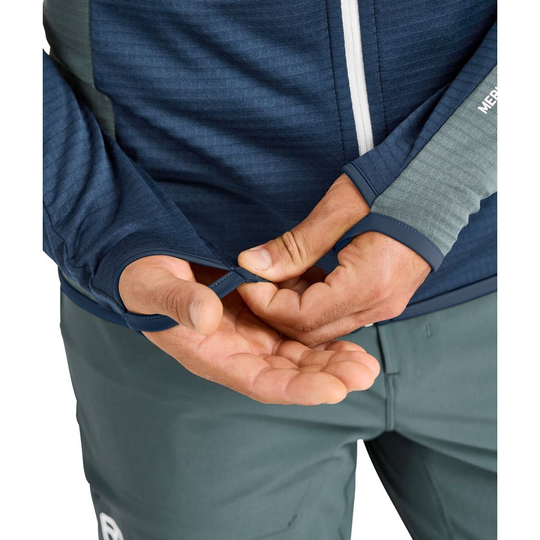 Fleece Light Grid Hooded Jkt shown with thumb loops for warmth and freedom of movement, featuring lightweight Merino wool blend.