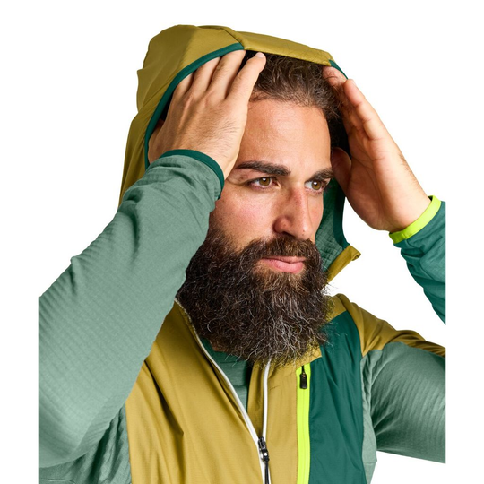 Ladiz Hybrid Jacket M with windproof inserts and Merino wool, showing protective hood feature.