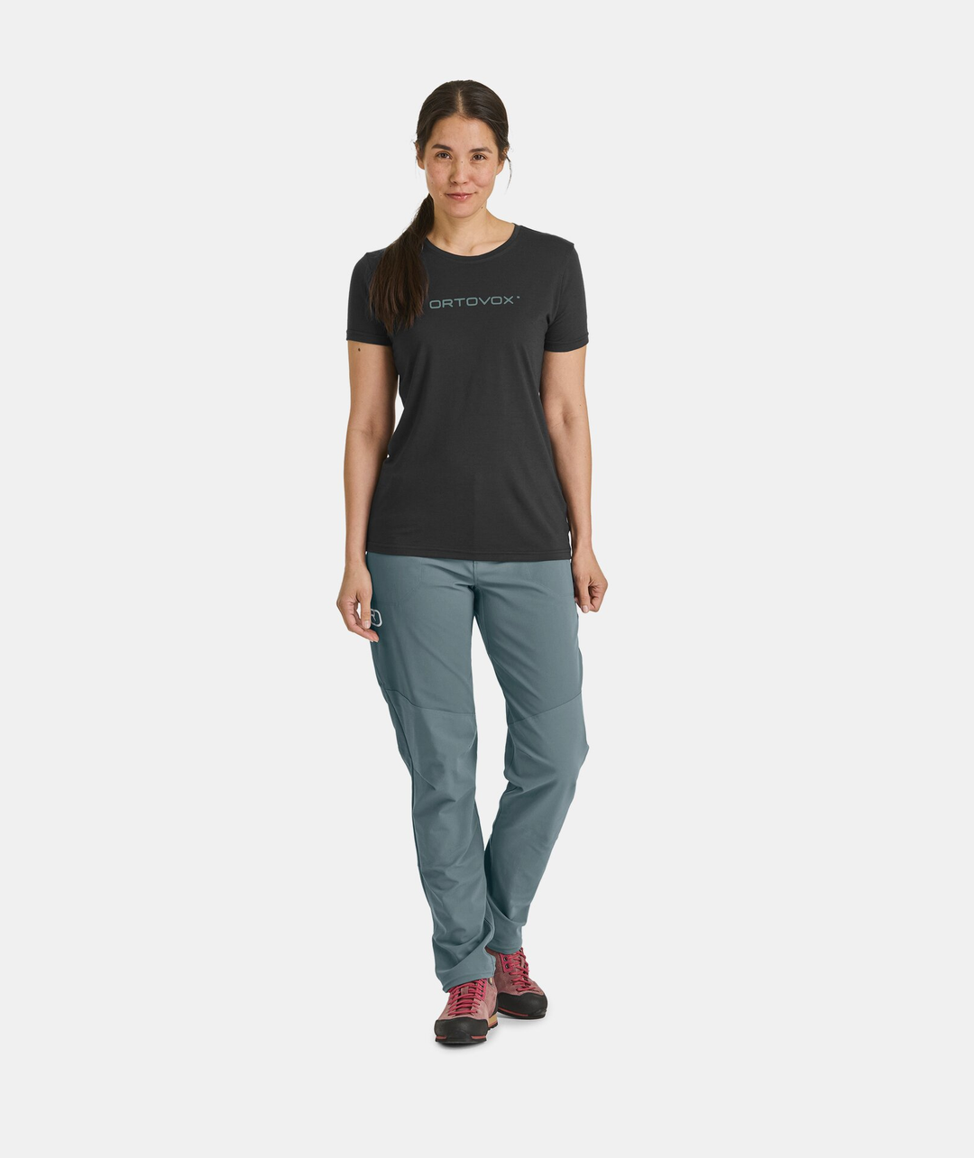 Woman wearing Pala Pants, durable with Merino wool, ideal for alpine climbing.
