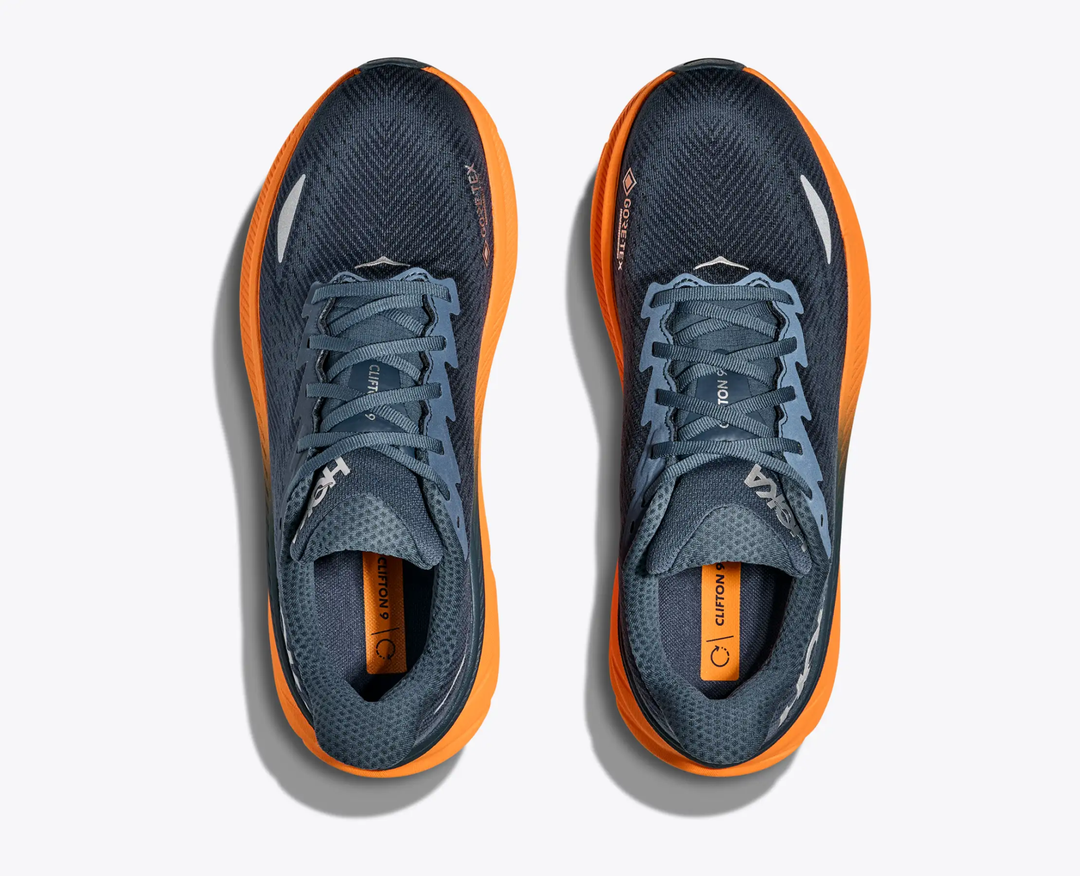 Clifton 9 Gtx running shoes with GORE-TEX, navy mesh, and orange soles.