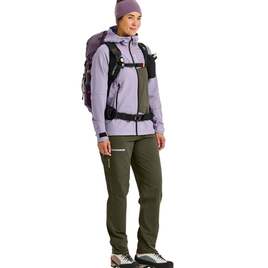 Traversing mountains with the Traverse 38 S backpack for multi-day hikes, shown on a person in outdoor gear.