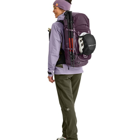 Traverse 38 S backpack in use, featuring helmet attachment, ergonomic straps, and multiple compartments.