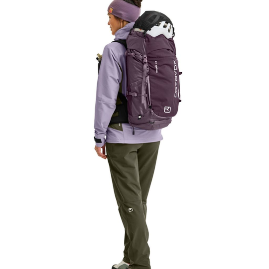 Traverse 38 S hiking backpack with helmet holder, ergonomic straps, and multiple compartments for gear storage.