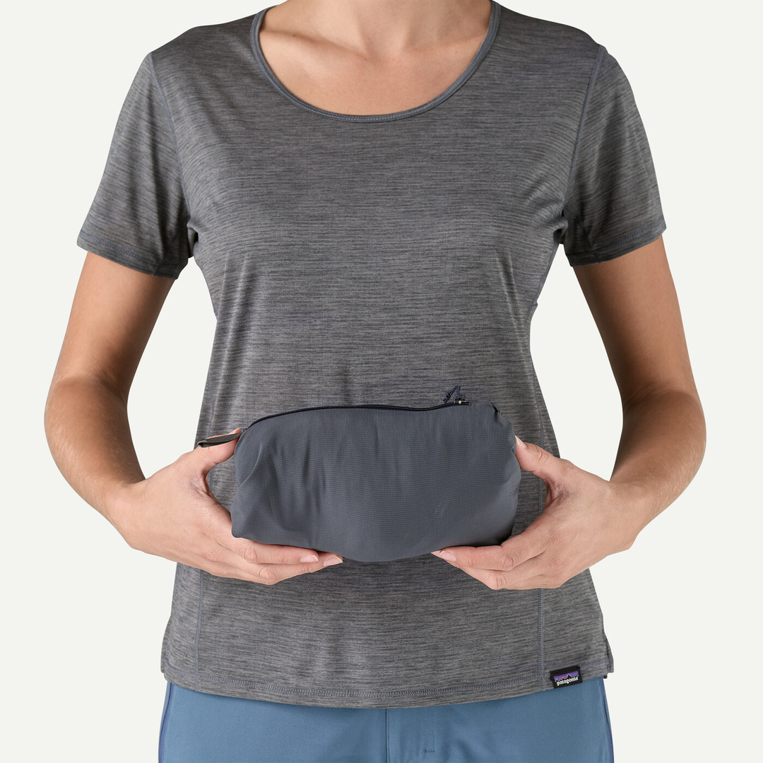 W's Nano-Air Ultralight Hoody packed in pocket, held by person wearing grey shirt.