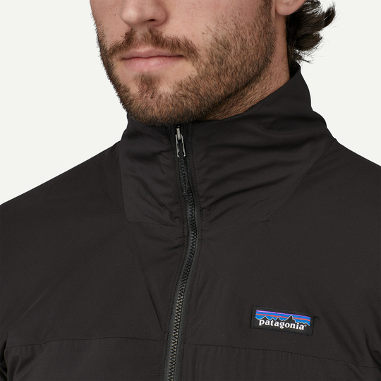 Nano-Air Light Hybrid Jacket, close-up on person wearing black jacket with Patagonia logo, showcasing breathable fabric and zip design.