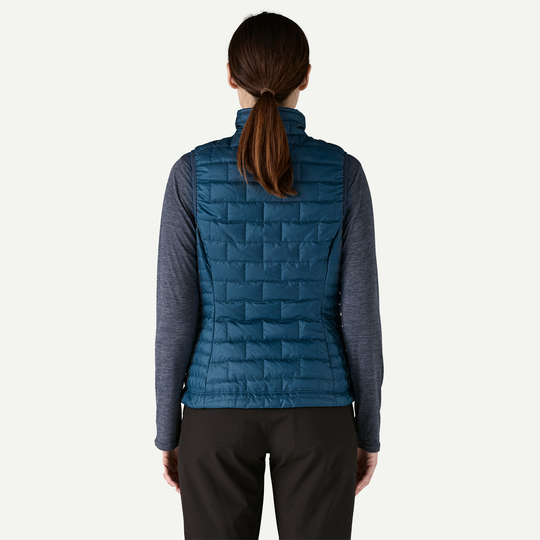 W's Nano Puff Vest in blue, lightweight and windproof, made from 100% recycled polyester with PrimaLoft Gold Insulation Eco, worn by a model viewed from the back.