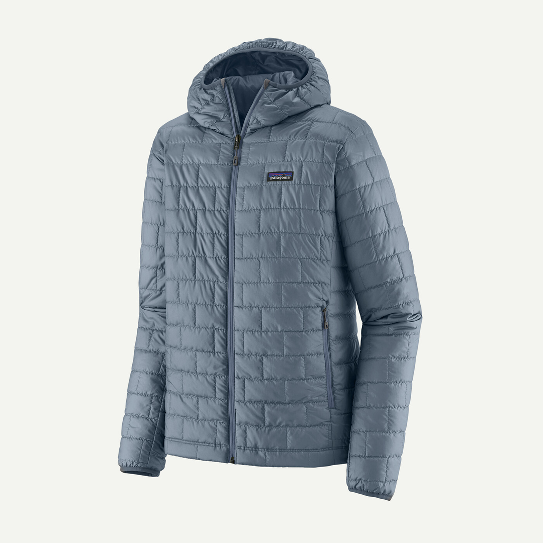 Nano Puff Hoody in light blue, made from recycled polyester with PrimaLoft Gold Insulation, featuring a quilted design and zippered pockets.