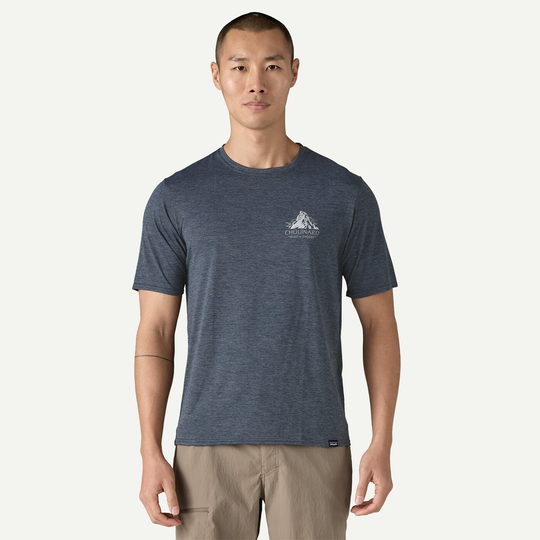 Men's Cap Cool Daily Graphic Shirt in blue, versatile technical fabric, offers quick-drying, flexibility, odor control, made with recycled polyester, Fair Trade Certified.