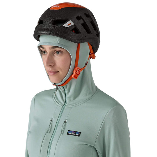 Woman wearing W's R1 Thermal Full-Zip Hoody, helmet-compatible hood, light blue color.