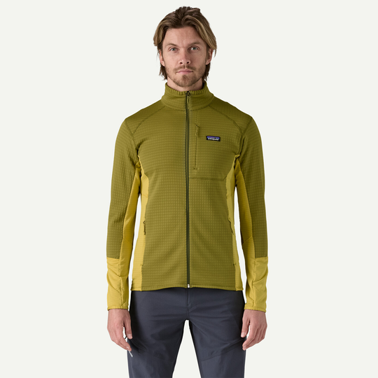 Lightweight and breathable R1 Jkt in green, featuring Polartec® Power Grid™ fabric and zip pockets. Ideal for cold-weather activities.