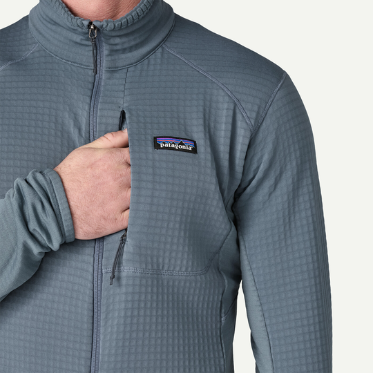 Lightweight and breathable R1 Jacket with zippered chest pocket and grid pattern fabric.