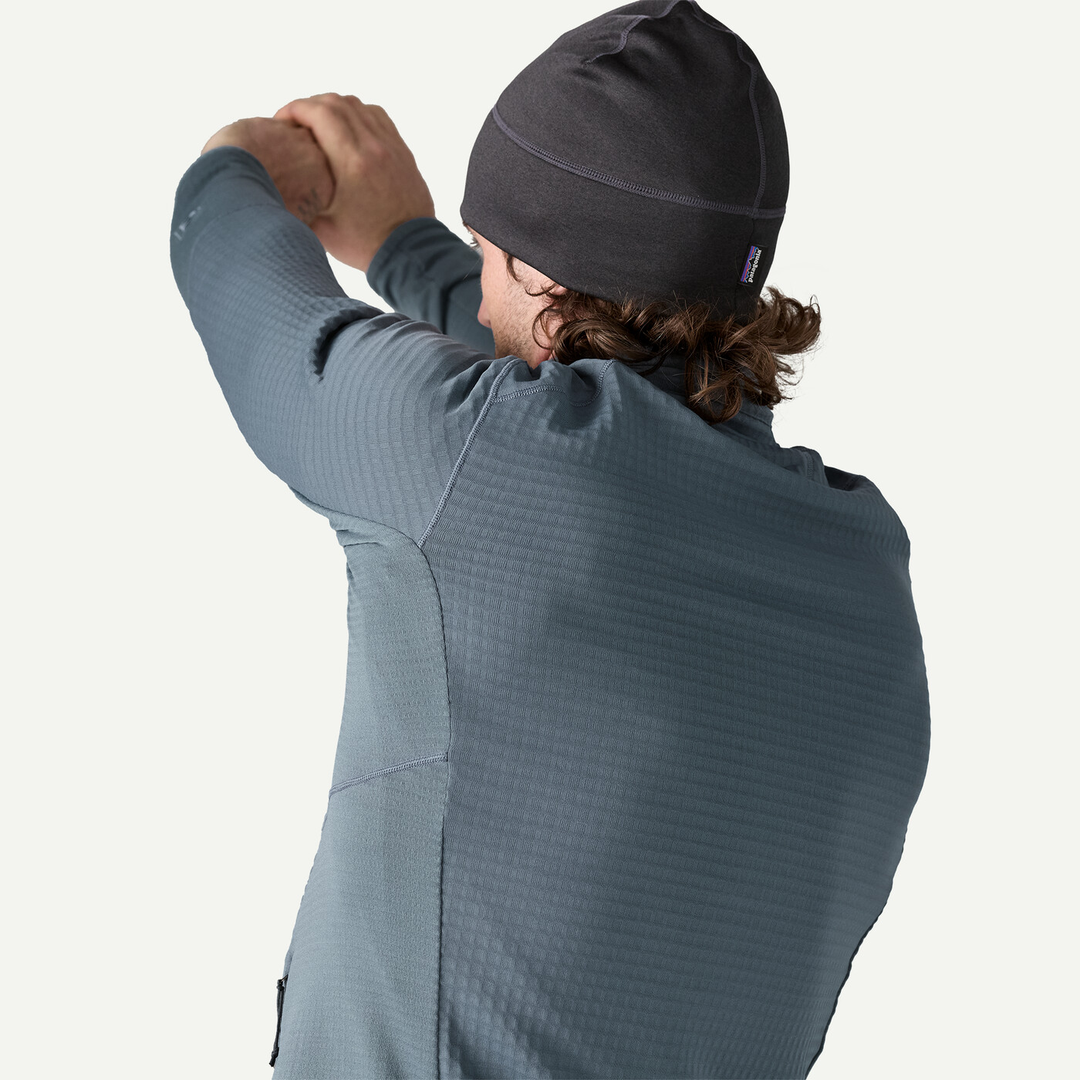 R1 Jkt in blue, rear view showing stretch and breathable fabric ideal for cold weather activities and layering.