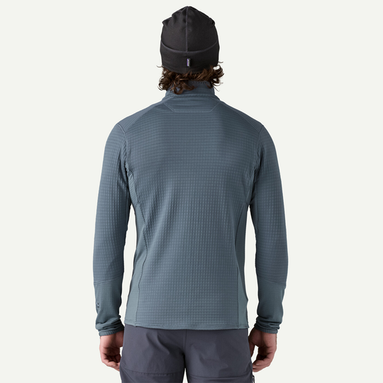 Back view of a man wearing the versatile Patagonia R1 Jkt in a mountain setting.