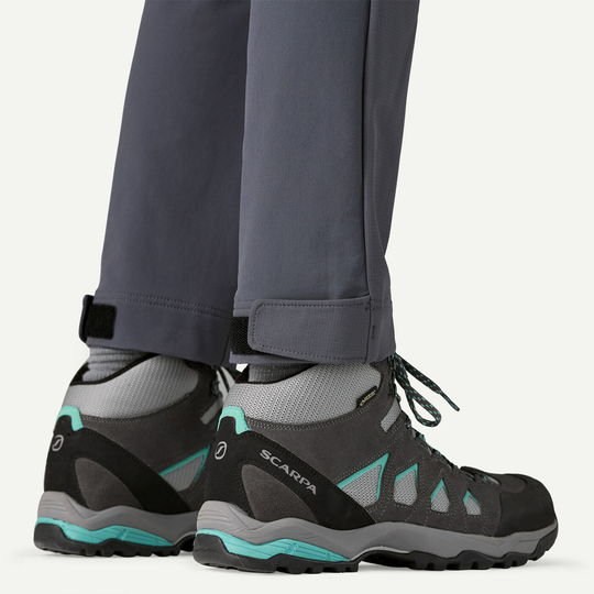 Terravia Peak Pants showing adjustable leg opening over hiking boots.
