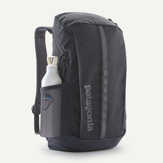 Black Hole Pack 25L backpack, durable recycled polyester, black, side water bottle pocket, front storage pocket, Patagonia logo.
