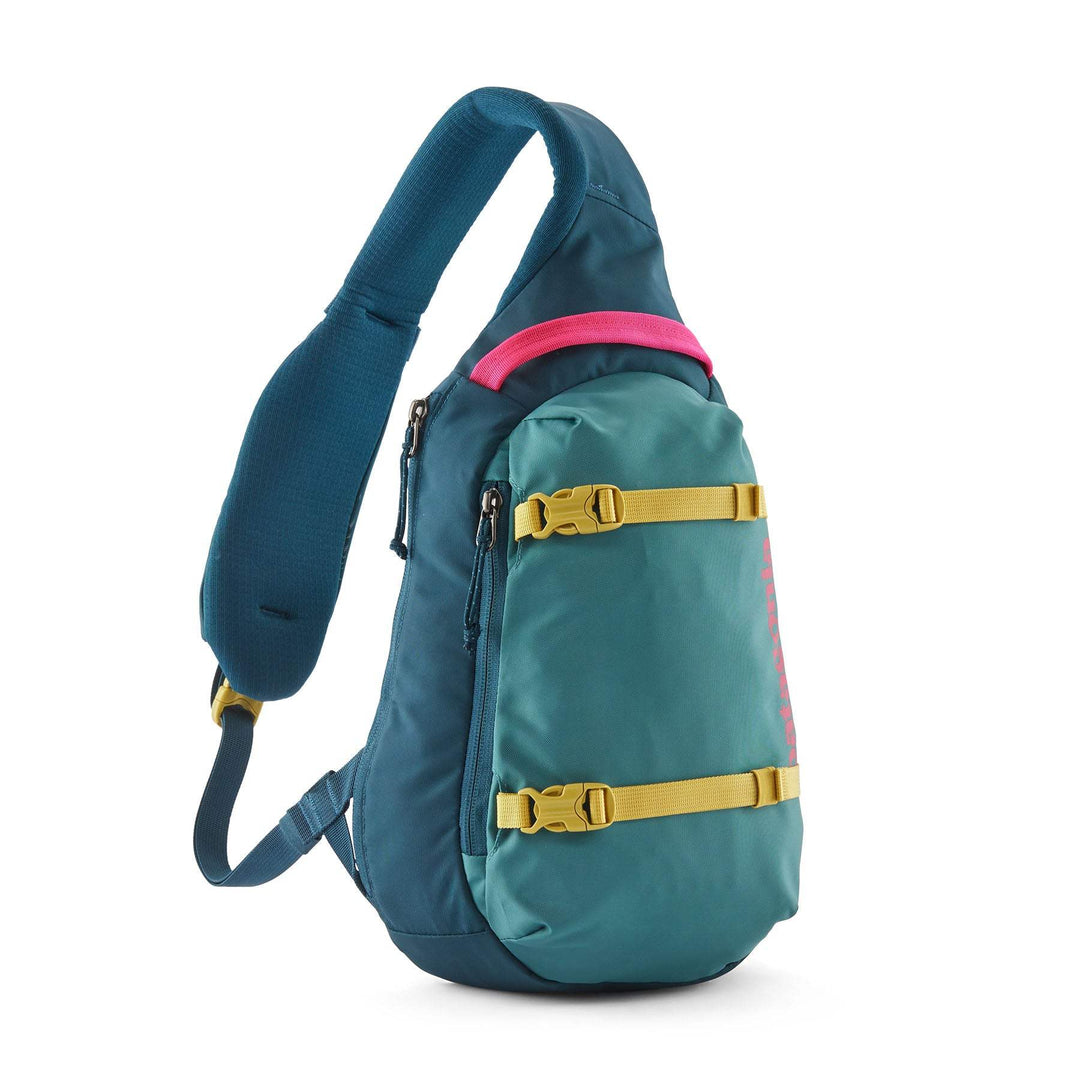 Sling backpack in blue and green with yellow straps, ergonomic single-shoulder design, and zippered front pocket, Atom Sling 8L.
