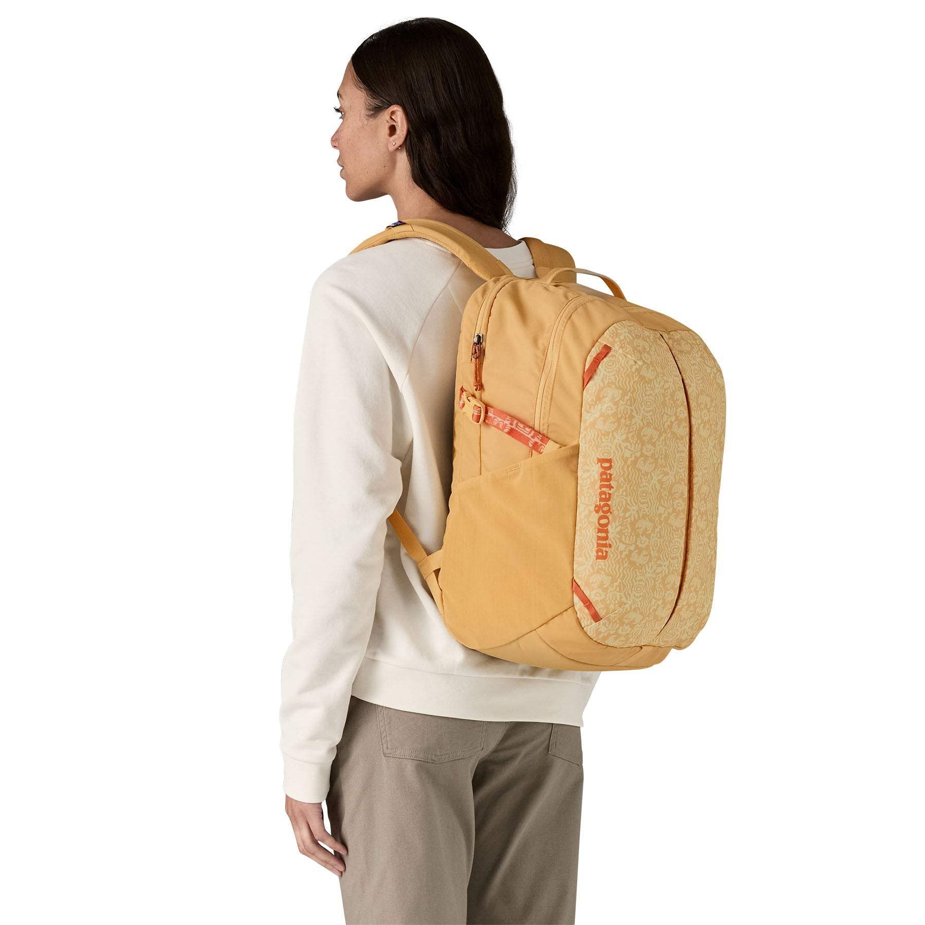 Refugio Day Pack 26L backpack shown on person, featuring recycled polyester and PFC-free DWR coating.