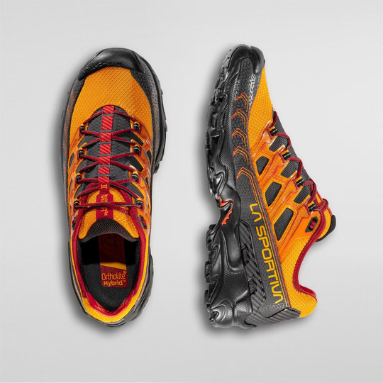 Trail running shoe Ultra Raptor II in orange and black, featuring breathable air-mesh upper and stabilizing heel for long-distance off-road use.