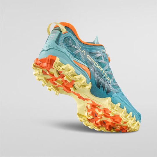 Bushido III Woman trail running shoe with vibrant grip-enhancing sole and breathable mesh upper.